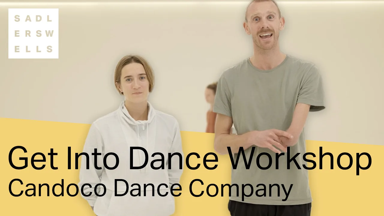 A male and female dancer from Candoco Dance Company standing and smiling