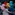 Fourteen dancers wearing bold colours spin